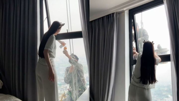 Mát lòng cảnh cô gái mời nước anh thợ treo mình giữa trời nóng lau kính cao ốc
